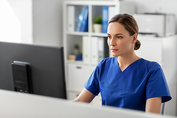 Image showing doctor or nurse with computer working at hospital