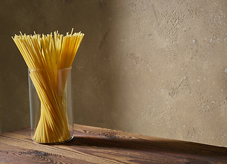 Image showing spaghetti pasta on brown wooden shelf
