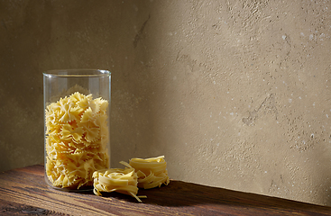 Image showing various pasta on brown wooden shelf