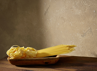 Image showing various pasta on brown wooden shelf