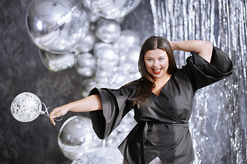 Image showing Happy plus size woman dancing at the party