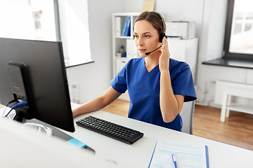 Image showing doctor with headset and computer at hospital