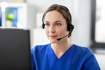 Image showing doctor with headset and computer at hospital