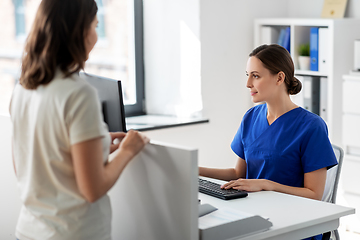 Image showing doctor with computer and patient at hospital