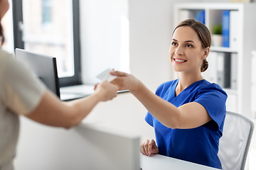 Image showing doctor and patient with prescription at hospital