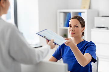 Image showing doctor and nurse with clipboard at hospital