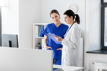 Image showing doctor and nurse with clipboard at hospital