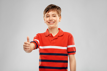 Image showing happy boy in red polo t-shirt showing thumbs up