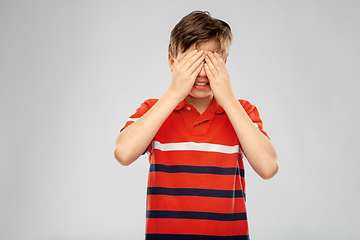 Image showing scared boy closing eyes with hands