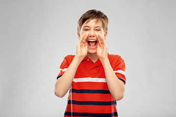 Image showing boy in red polo t-shirt shouting or calling