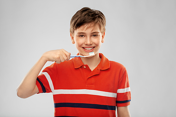 Image showing happy boy brushing teeth with toothbrush