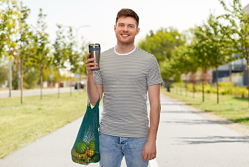 Image showing man with food in bag and tumbler or thermo cup