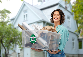 Image showing happy smiling young woman sorting paper waste