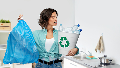 Image showing smiling woman sorting plastic waste and trash bag