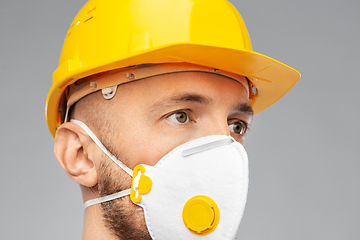 Image showing male worker or builder in helmet and respirator