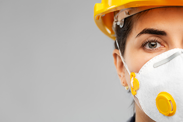 Image showing female worker or builder in helmet and respirator