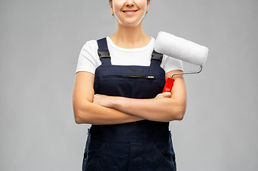 Image showing happy female worker or builder with paint roller