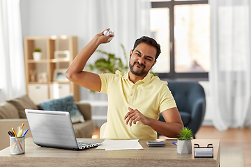 Image showing angry man throwing crumpled paper at home office