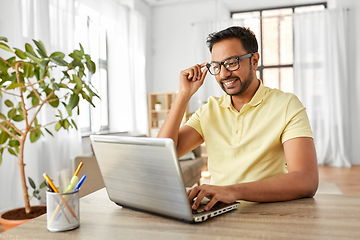 Image showing indian man with laptop working at home office