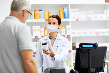 Image showing apothecary in mask and senior customer at pharmacy