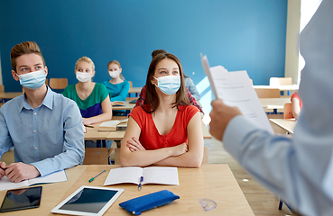 Image showing group of students in masks and teacher at school