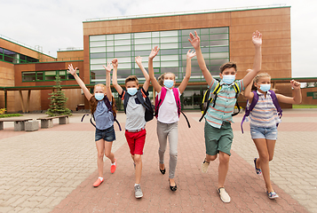 Image showing group of happy students in masks leaving school