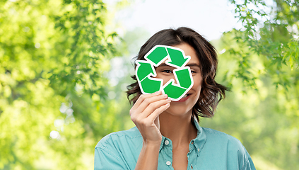 Image showing smiling woman looking through green recycling sign