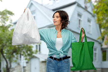 Image showing woman with plastic and reusable shopping bag