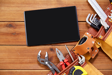 Image showing tablet computer and tool belt on wooden boards