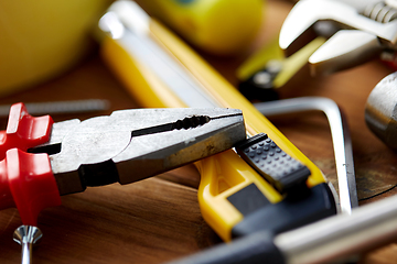 Image showing pliers and different work tools on wooden boards