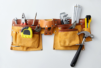 Image showing different work tools in belt on white background