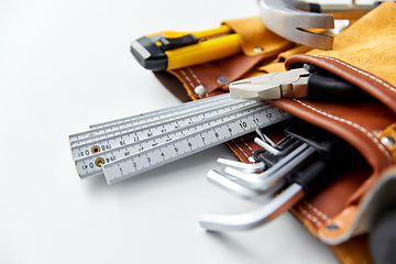 Image showing different work tools in belt on white background