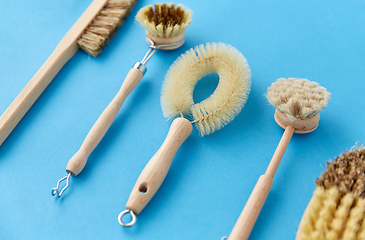 Image showing different cleaning brushes on blue background