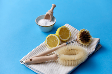 Image showing cleaning brushes, lemon and washing soda on cloth