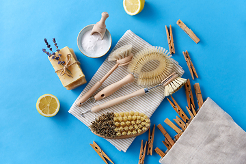 Image showing cleaning brushes, lemon and wooden clothespins