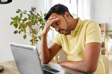 Image showing indian man with laptop working at home office