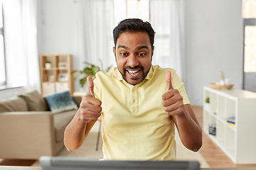 Image showing man with laptop has video chat and shows thumbs up