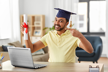 Image showing indian student with laptop and diploma at home