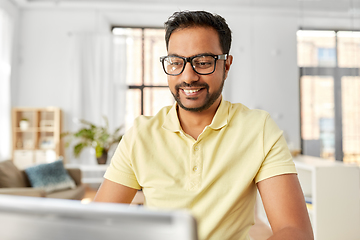 Image showing indian man with laptop working at home office