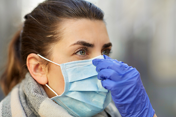 Image showing young woman wearing protective medical mask