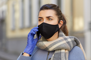 Image showing woman in protective reusable mask calling on phone