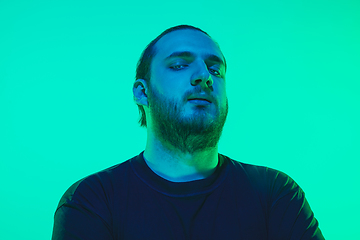 Image showing Portrait of a guy with colorful neon light on green background - cyberpunk concept