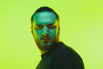 Image showing Portrait of a guy with colorful neon light on green background - cyberpunk concept