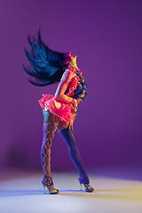 Image showing Attractive hawaiian brunette model on purple studio background in neon light