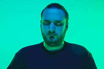 Image showing Portrait of a guy with colorful neon light on green background - cyberpunk concept