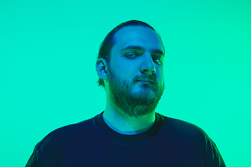 Image showing Portrait of a guy with colorful neon light on green background - cyberpunk concept