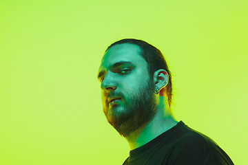 Image showing Portrait of a guy with colorful neon light on green background - cyberpunk concept