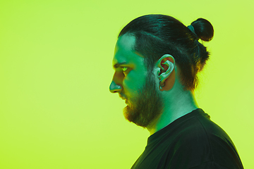 Image showing Portrait of a guy with colorful neon light on green background - cyberpunk concept