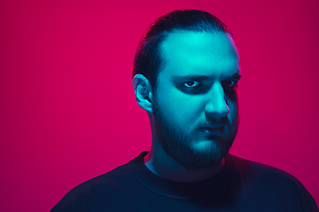 Image showing Portrait of a guy with colorful neon light on pink background - cyberpunk concept