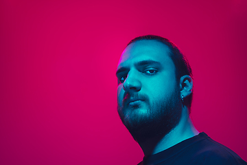 Image showing Portrait of a guy with colorful neon light on pink background - cyberpunk concept